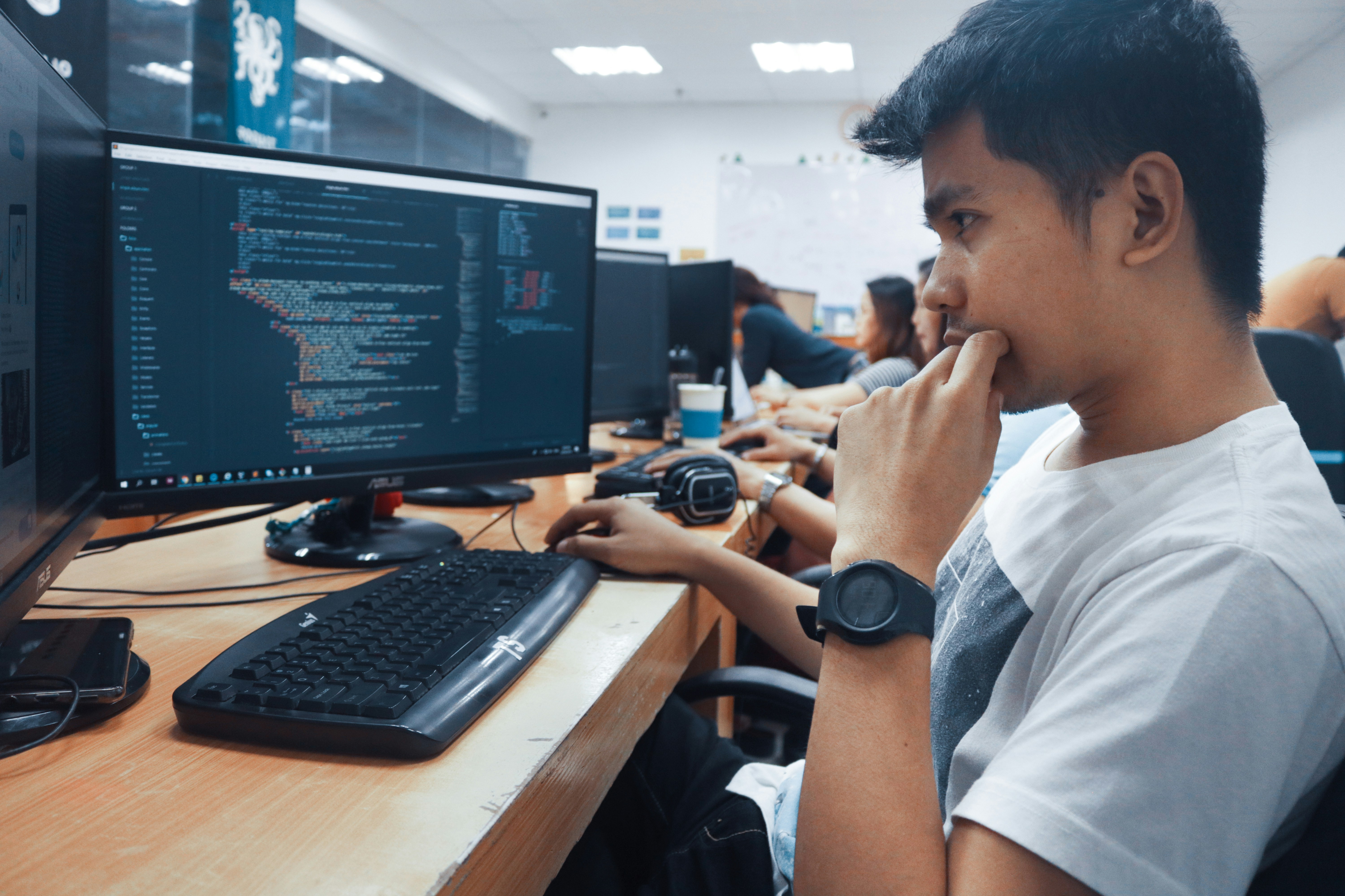 Modern office with developers collaborating on code